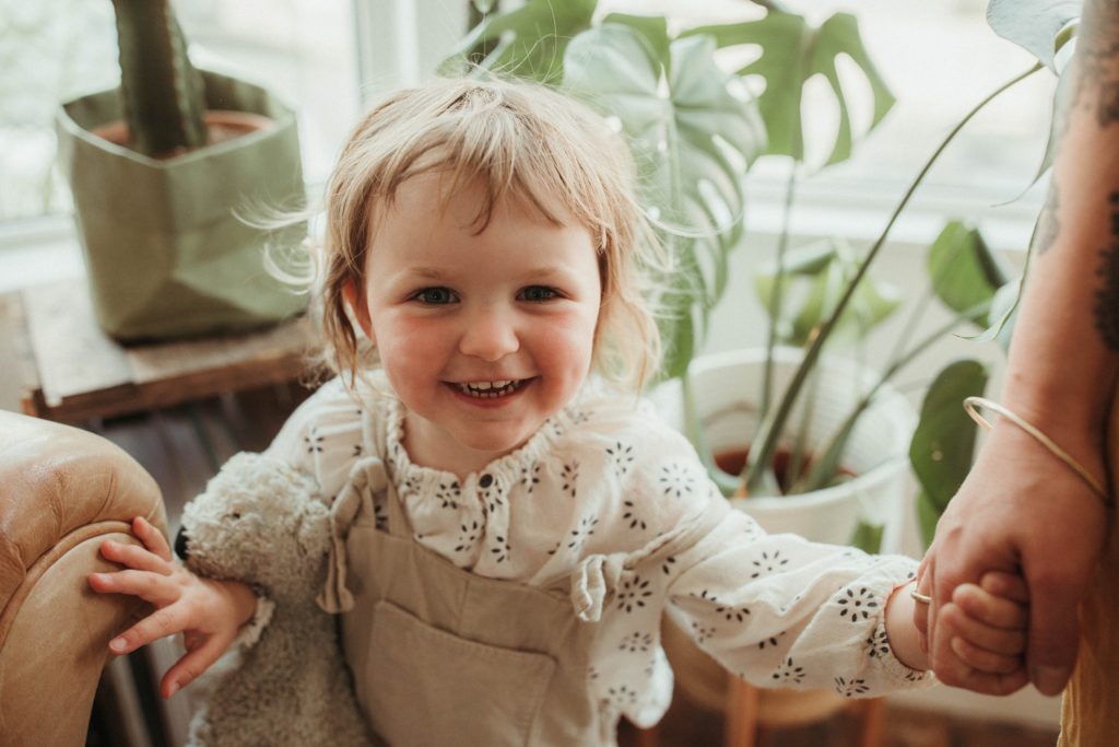 portrait photographer cornwall toddler smiling photographed at a family session at home