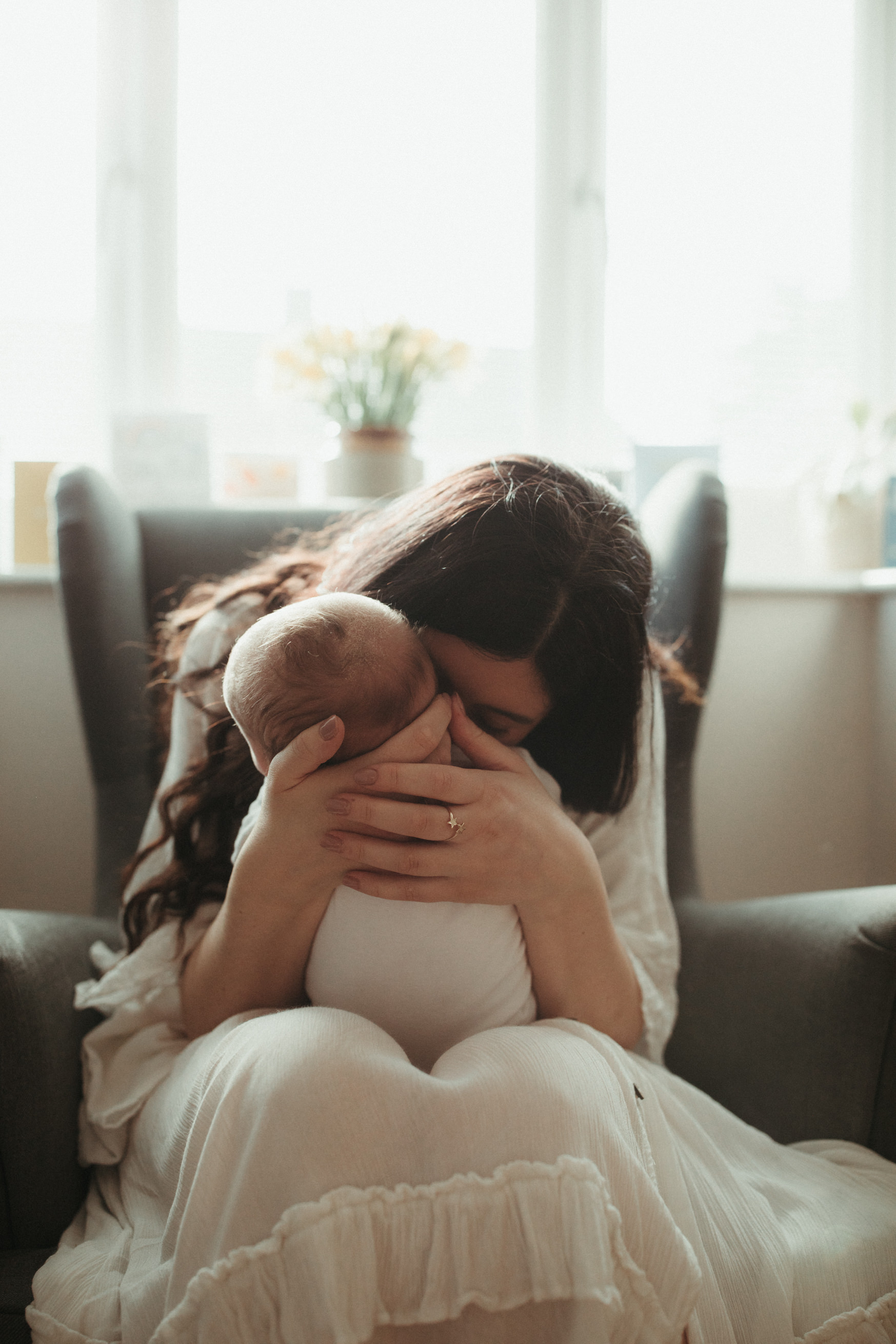 new mother breathes in newborn