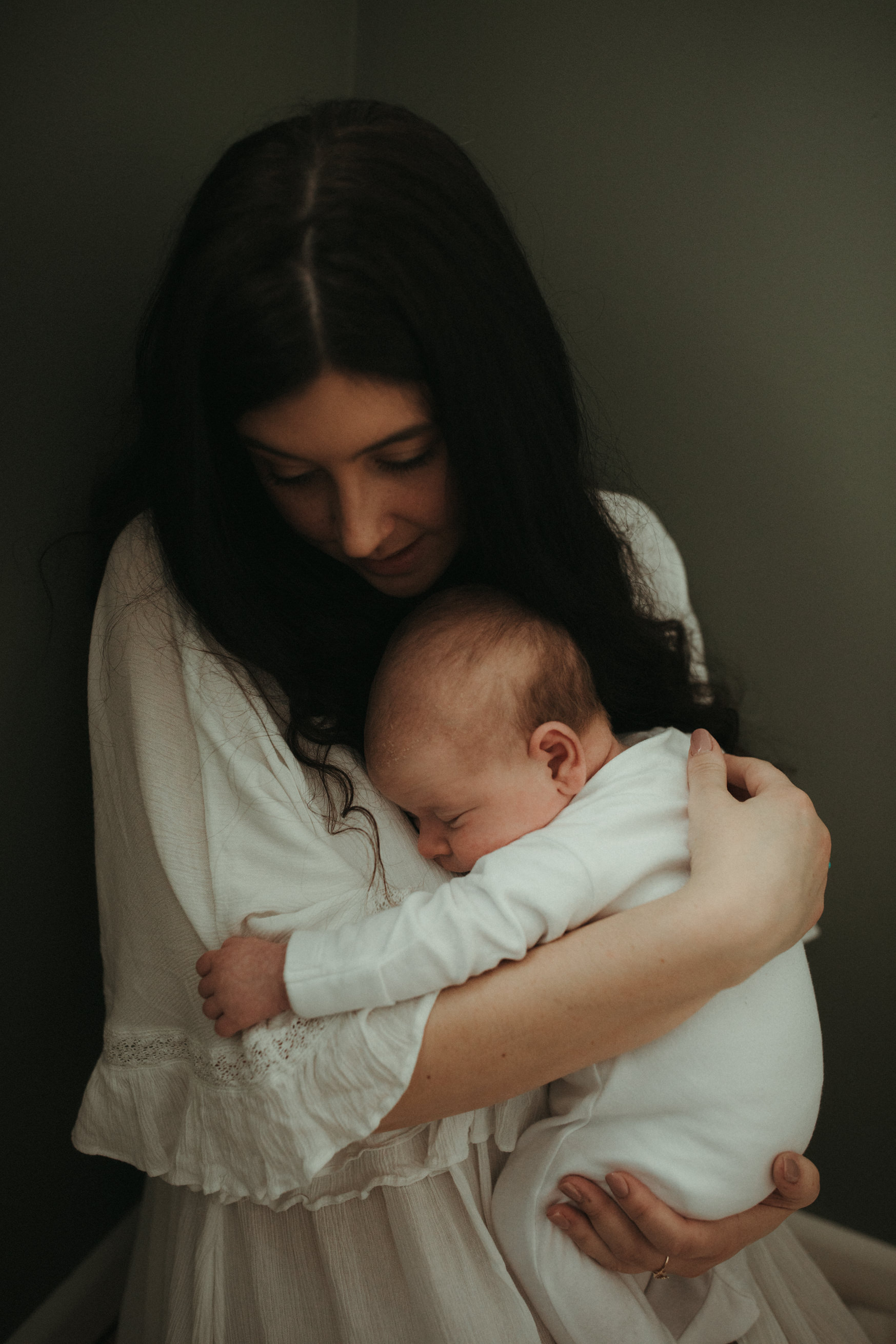 shot of newborn snuggling into mum Maternity and Newborn Photographer Devon 
