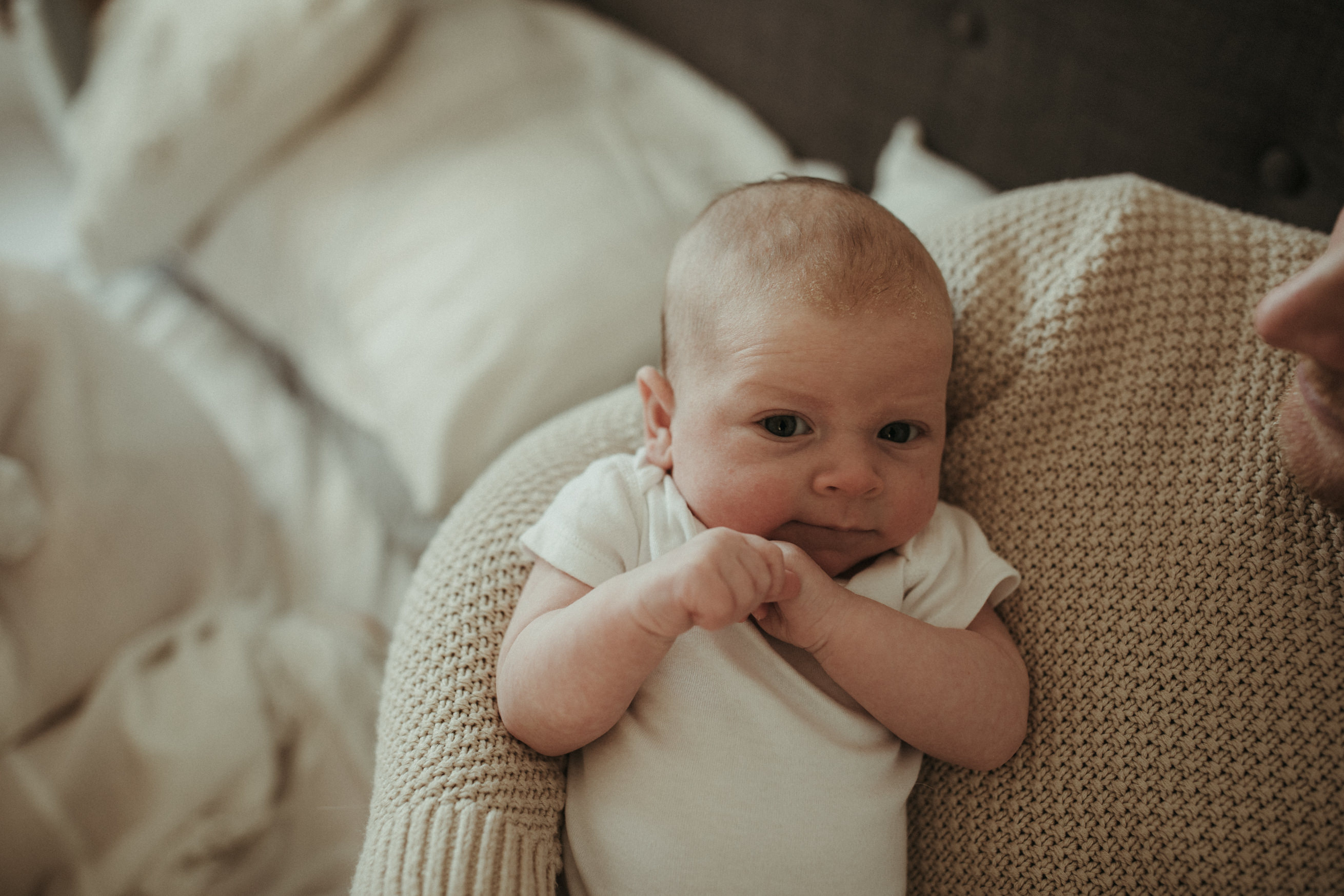 newborn looks directly at camera