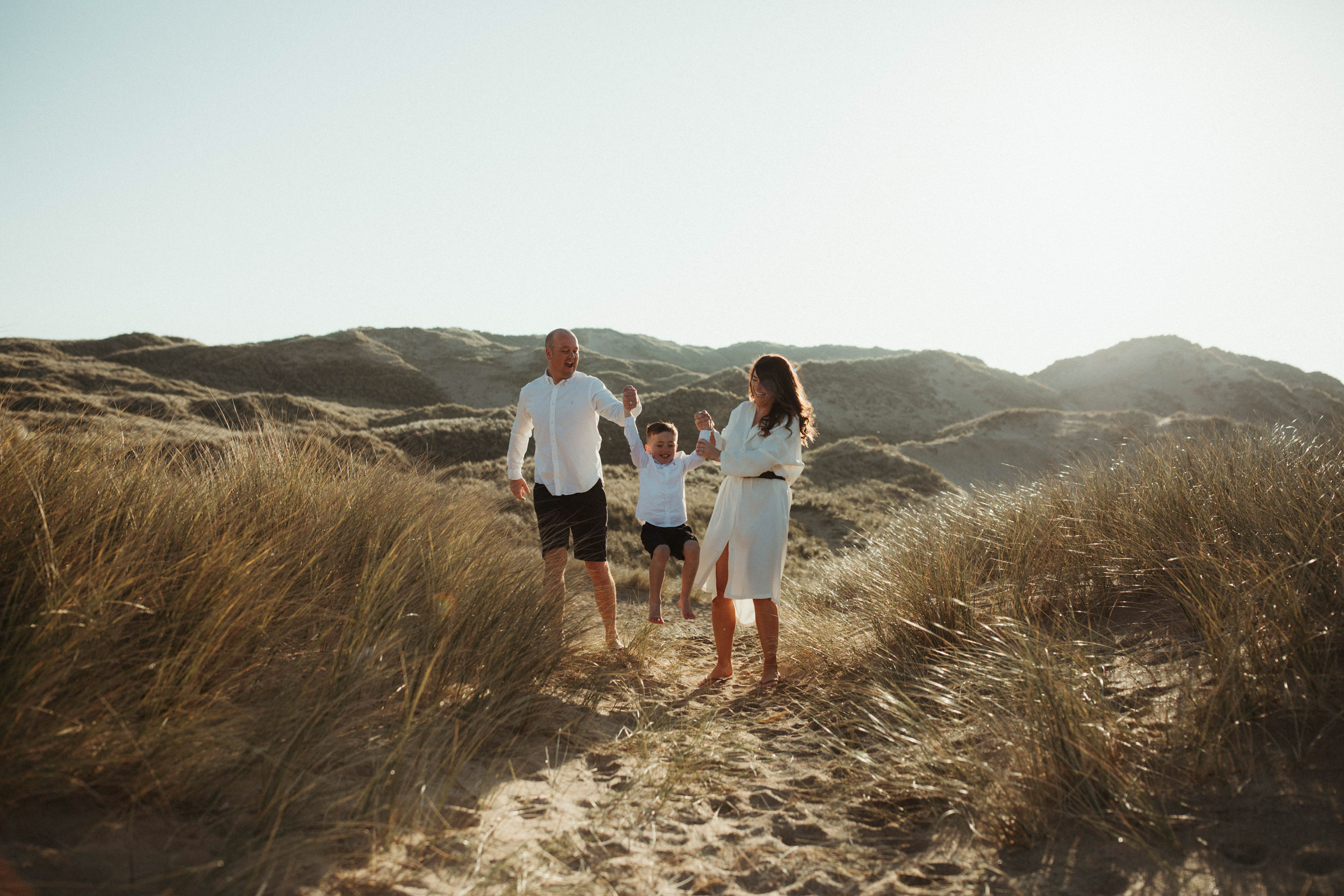 Family swing son in sand dunes Family Lifestyle Photography