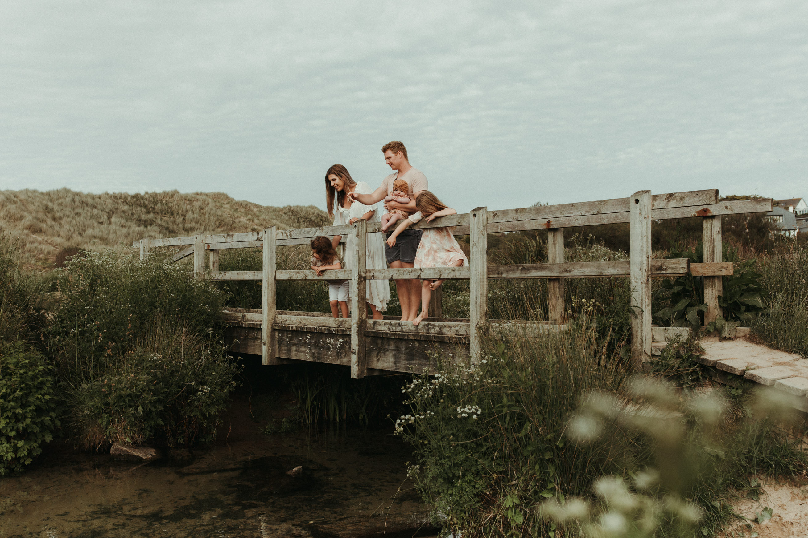 Family look over bridge for boho family photos