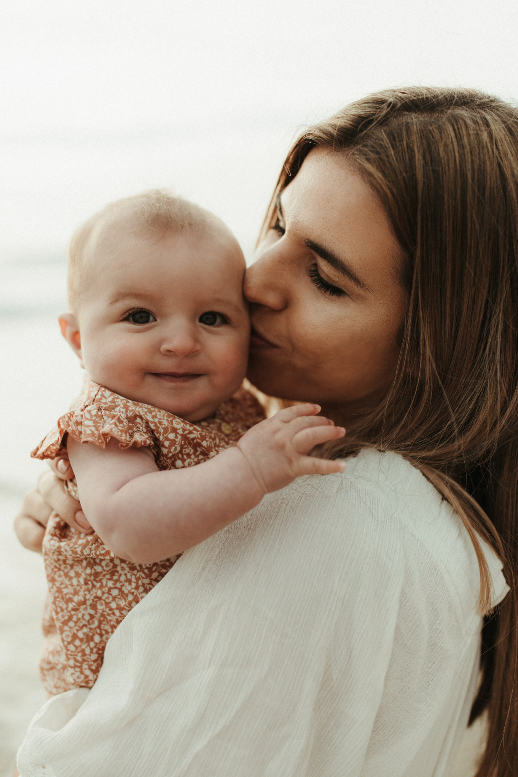 Mother kisses baby