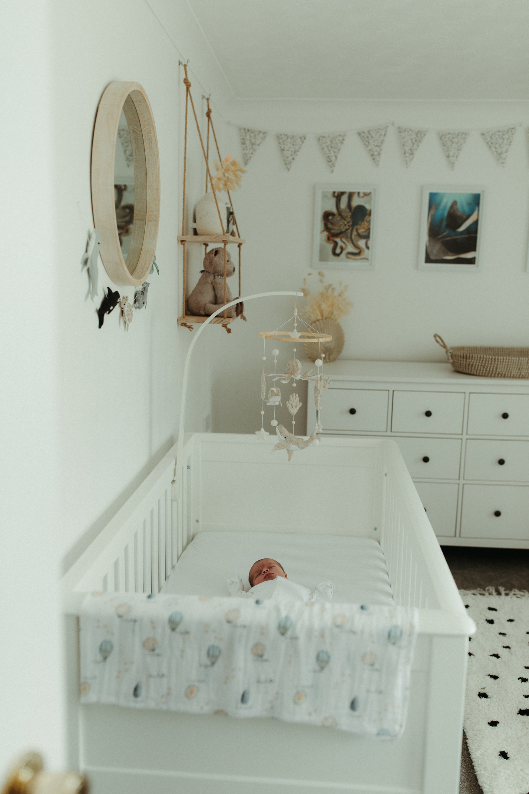 baby in cot in nursery