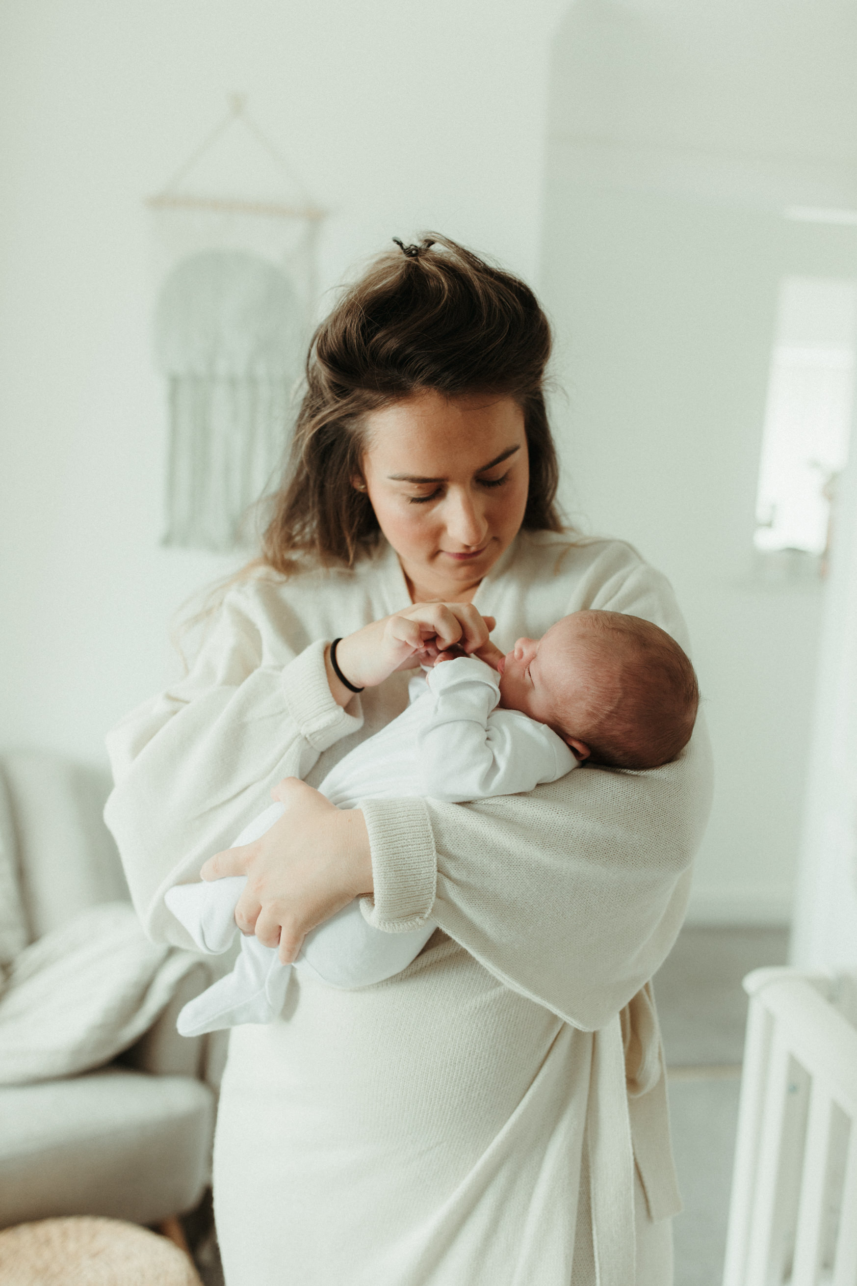 Mum holding baby in nursery Baby Photography Cornwall